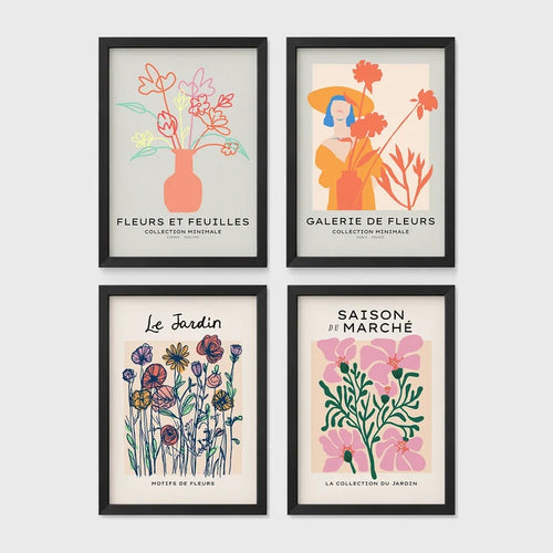 Set of 4 framed prints, pop art and vintage-poster mix: a Warhol-style pop art skull in orange on blue; an "L'atelier des Fleurs" floral botanical poster; a "Welcome To The Freak Show" vintage floral circus poster; and a still life with a skull and jar, overlaid with colourful polka dots — unframed