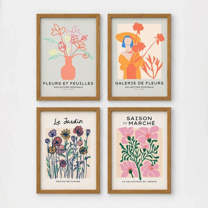 Set of 4 framed prints, pop art and vintage-poster mix: a Warhol-style pop art skull in orange on blue; an "L'atelier des Fleurs" floral botanical poster; a "Welcome To The Freak Show" vintage floral circus poster; and a still life with a skull and jar, overlaid with colourful polka dots — unframed