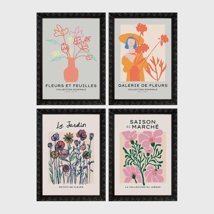 Set of 4 framed prints, pop art and vintage-poster mix: a Warhol-style pop art skull in orange on blue; an "L'atelier des Fleurs" floral botanical poster; a "Welcome To The Freak Show" vintage floral circus poster; and a still life with a skull and jar, overlaid with colourful polka dots — unframed
