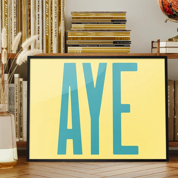 Aye Typography Quote Print - Duck Egg Blue framed on a living room bookshelf