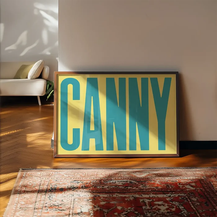 Canny Typography Quote Print - Duck Egg Blue framed, leaning on a wooden floor beside a rug