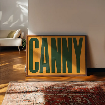 Canny Typography Quote Print - Forest Green framed, leaning on a wooden floor beside a rug