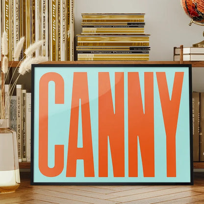 Canny Typography Quote Print - Orange framed on a living room bookshelf