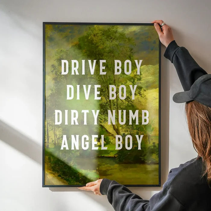 Drive Boy Dive Boy Born Slippy Quote Print being hung on a wall in a black frame