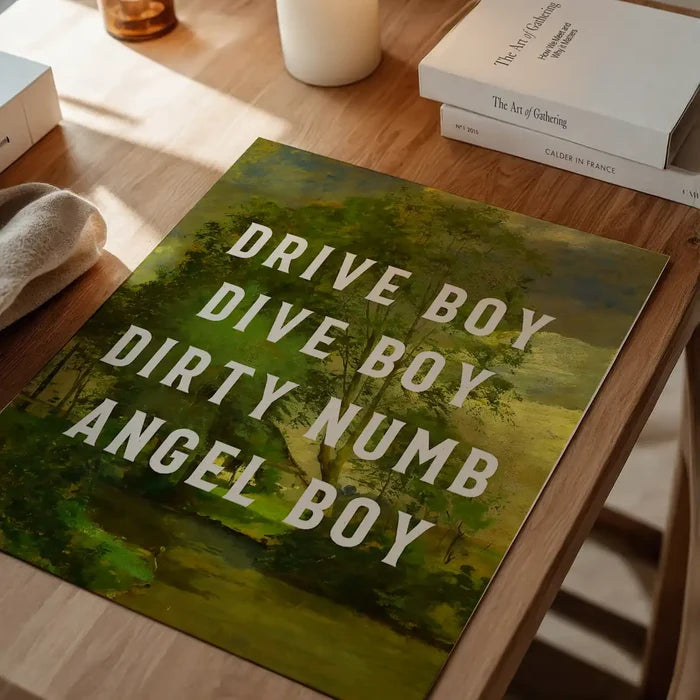 Drive Boy Dive Boy Born Slippy Quote Print unframed on a home office desk