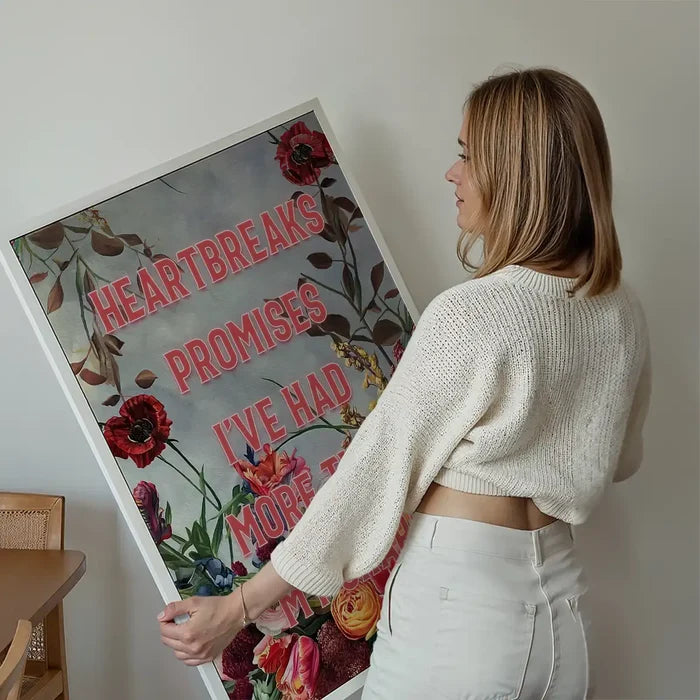 Heartbreak Promises Lyrics Quote Print held up against a living room wall