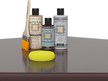 Retique It® Light Wood Wood’n Primer with Java Gel Stain Alternative, gloss topcoat, brush, and yellow sponge on a reflective tabletop.