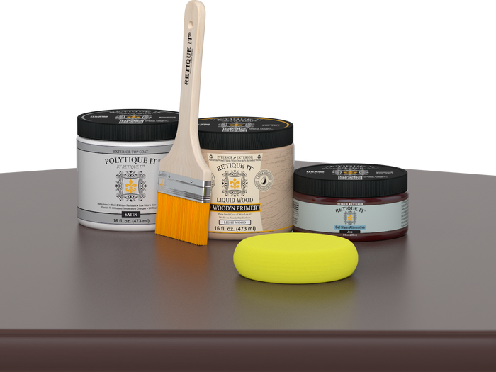 Retique It® Java Multipurpose Kit contents with Liquid Wood primer, Java gel stain alternative, PolyTique It® satin exterior top coat, paintbrush, and yellow sponge displayed on a dark wood surface.