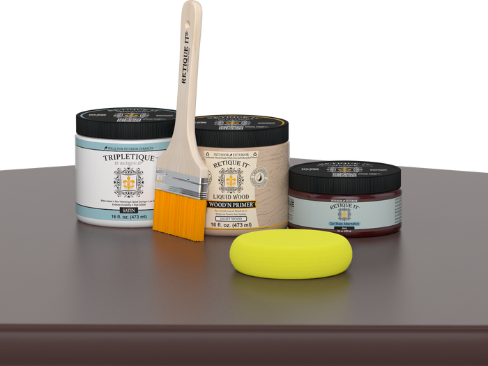 Retique It® Java Multipurpose Kit contents with Liquid Wood primer, Java gel stain alternative, Tripletique satin interior top coat, paintbrush, and yellow sponge displayed on a dark wood surface.