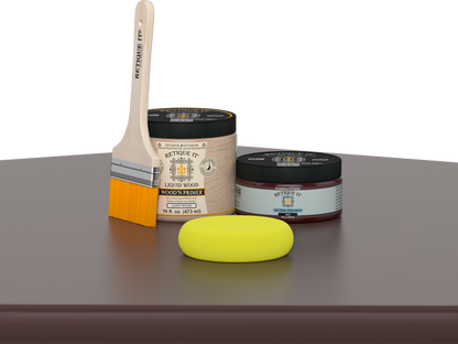 Retique It® Java Multipurpose Kit contents with Liquid Wood primer, Java gel stain alternative, paintbrush, and yellow sponge displayed on a dark wood surface.
