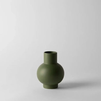 Green vase on a light gray background
