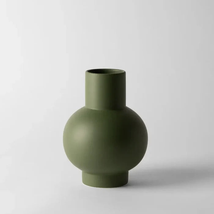 Green vase on a light gray background