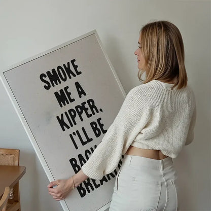 Smoke Me A Kipper Quote Print held up against a living room wall