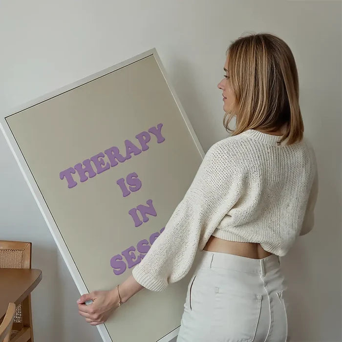 Therapy In Session Quote Print held up against a living room wall