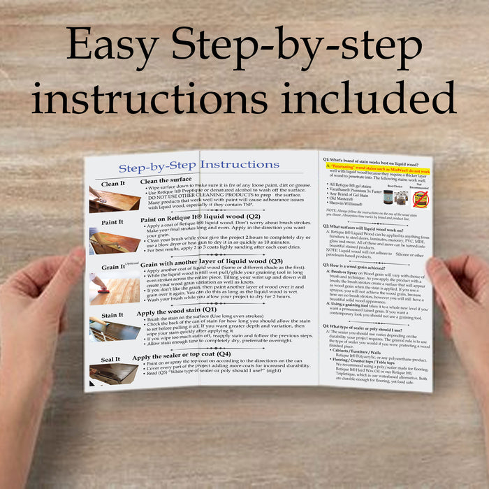 Hands holding an instructions book for Retique It Weathered Finish Kit in Rustic Red, showcasing wood finishing techniques.