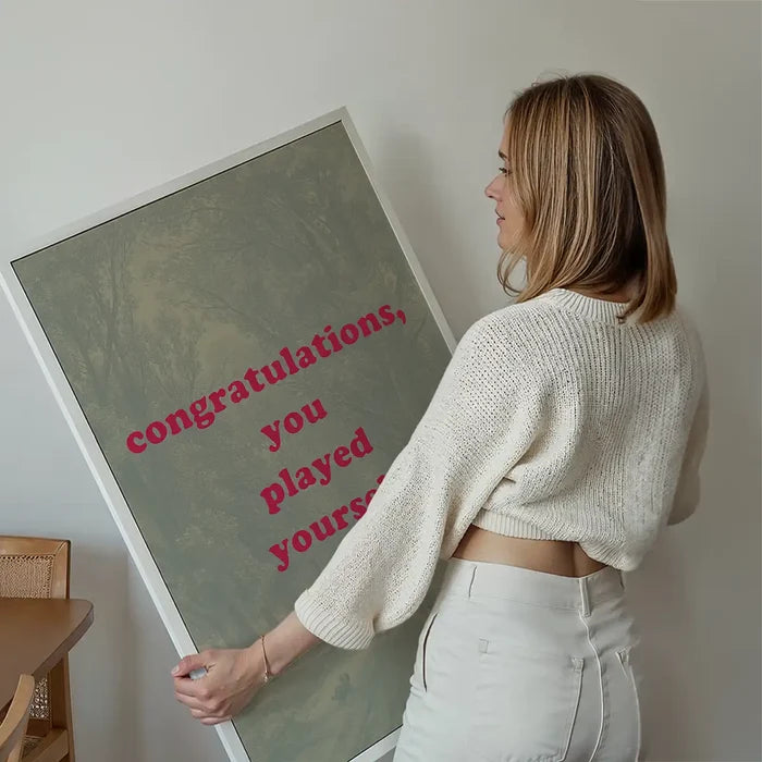 You Played Yourself Quote Print held up against a living room wall